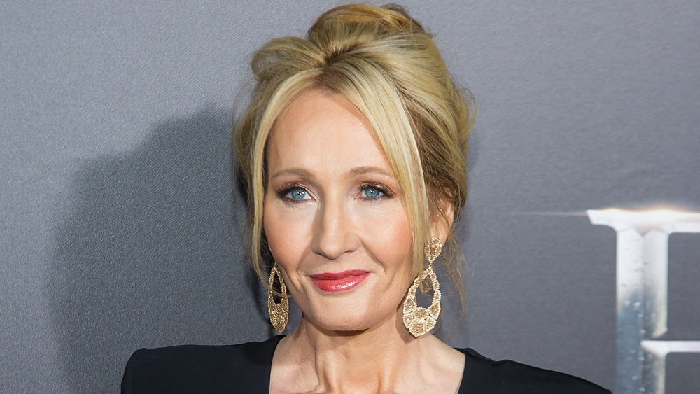 J.K. Rowling with long gold earrings