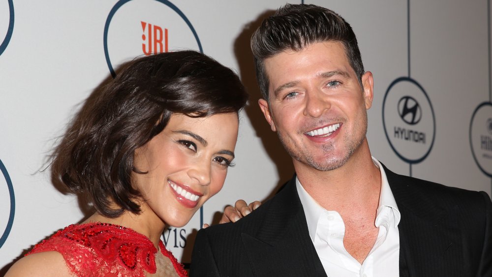 Paula Patton with hand on Robin Thicke's shoulder