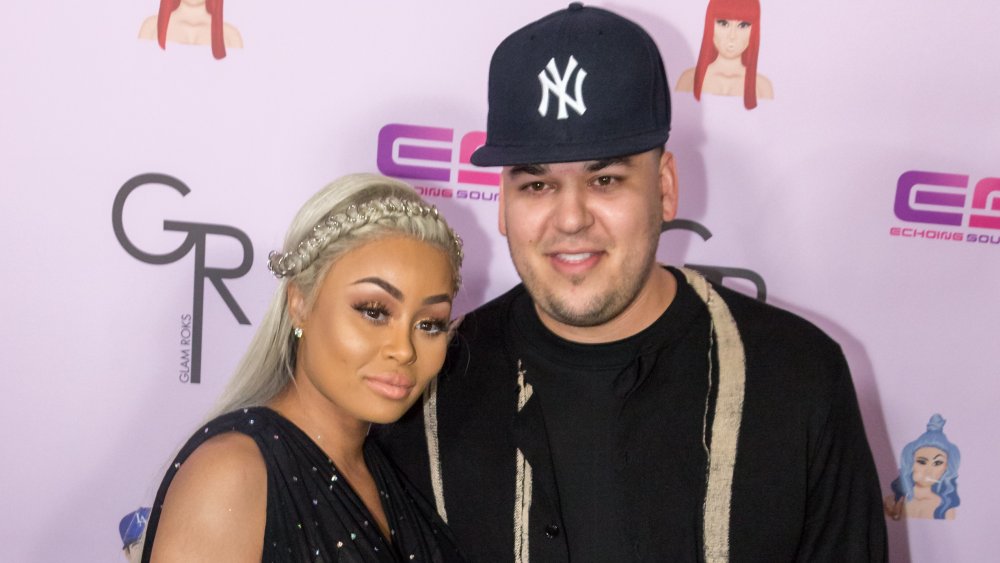 Blac Chyna and Rob Kardashian in front of pink wall