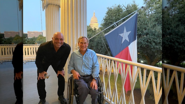Joe Rogan poses with Texas Governor Greg Abbott