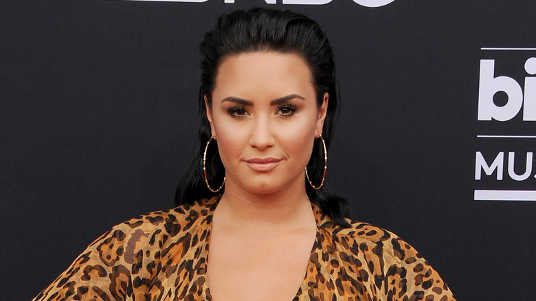 Demi Lovato wearing leopard print and smiling