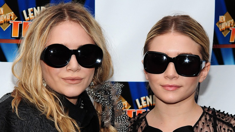 Mary-Kate and Ashley Olsen posing in sunglasses
