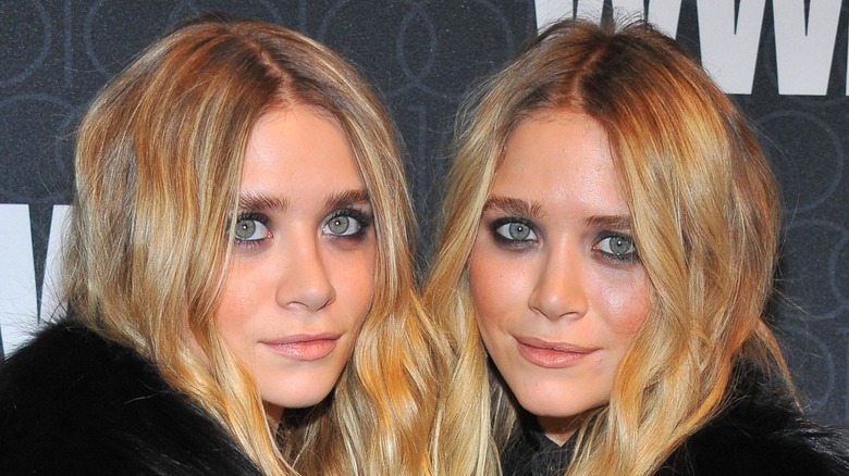 Mary-Kate and Ashley Olsen smirk