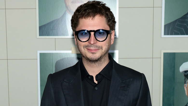 Michael Cera at a premiere wearing blue tinted glasses