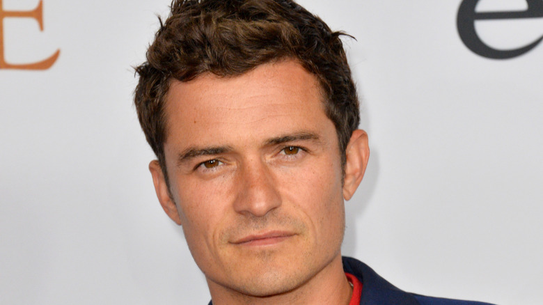 Orlando Bloom looking serious on red carpet