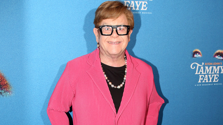 Elton John wearing a pink suit