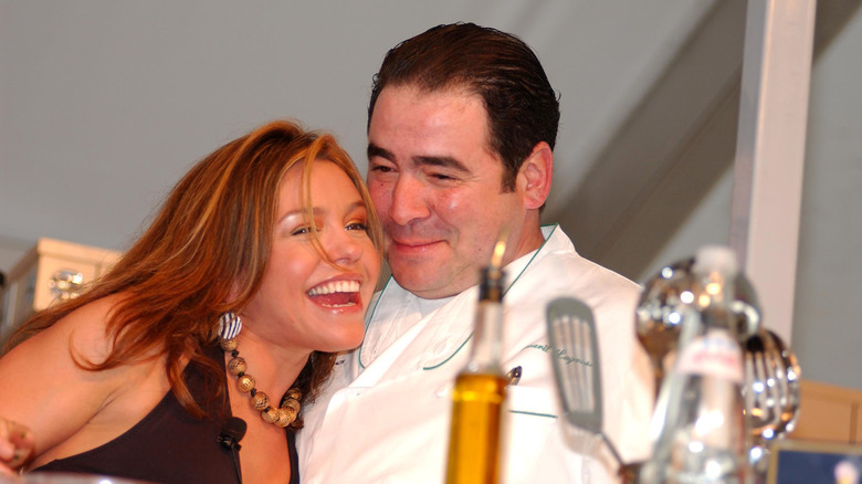 Rachael Ray and Emeril Lagasse laugh and hug