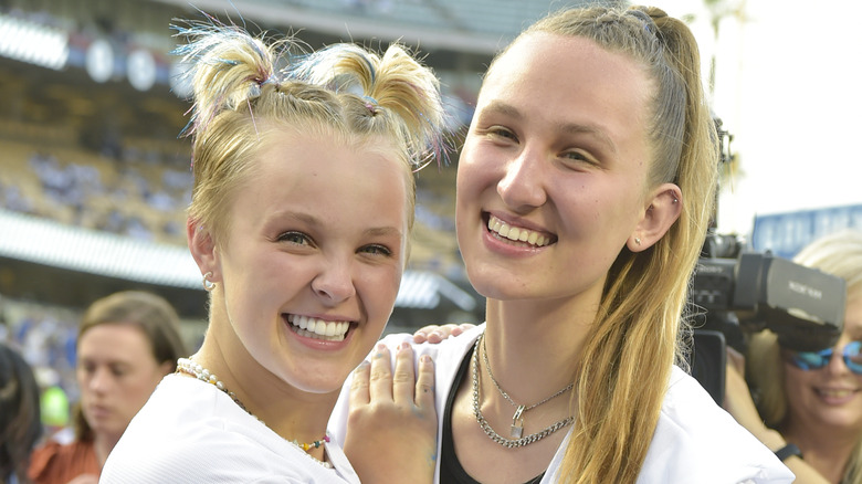 JoJo Siwa placing hand on Kylie Prew's shoulder