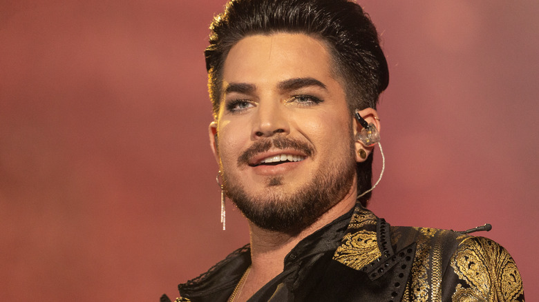 Adam Lambert smiling while performing