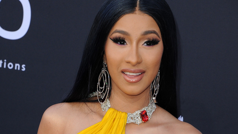 Cardi B smiling in yellow outfit 