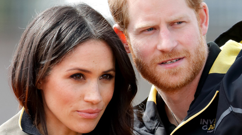 Meghan Markle and Prince Harry with serious expressions