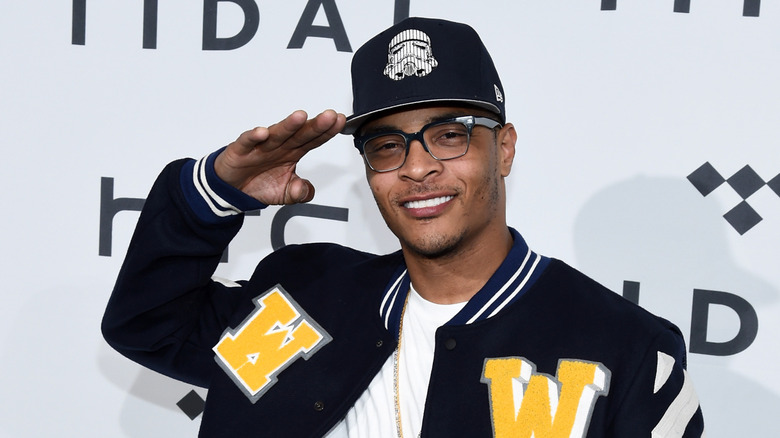 T.I. giving a salute and smiling