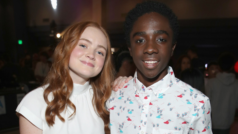 Sadie Sink placing hand on Caleb McLaughlin's shoulder