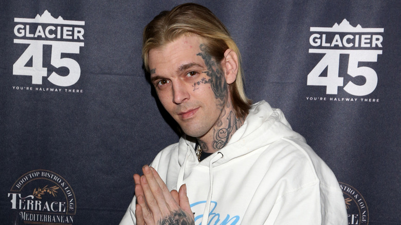 Aaron Carter wearing a white hoodie