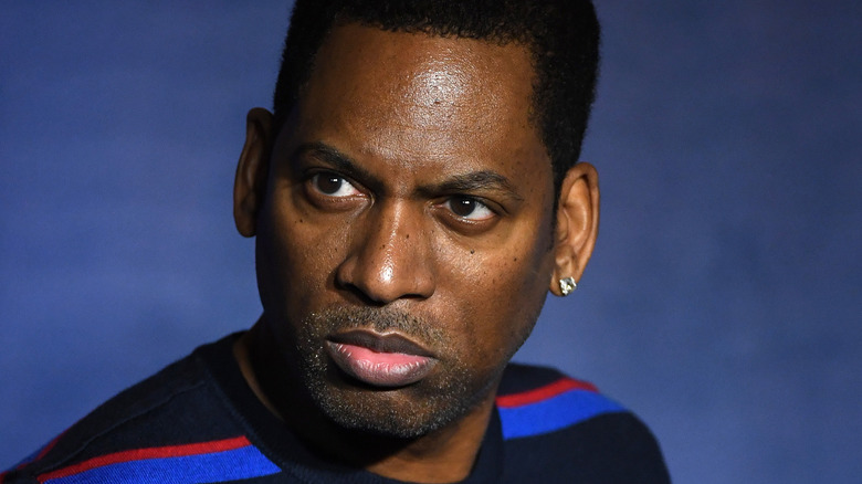 Tony Rock posing in a striped shirt
