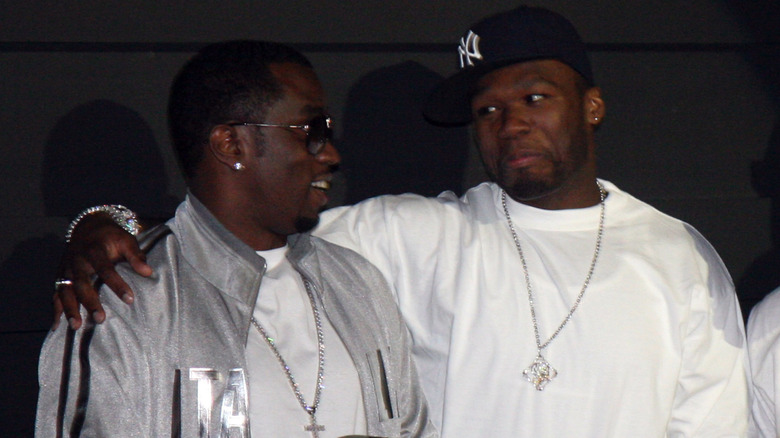 Diddy and 50 Cent hanging out at an event.