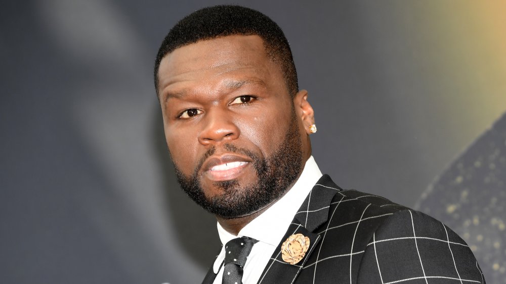 50 Cent in a black-and-white checkered suit