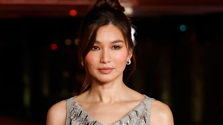 Gemma Chan posing in silver gown