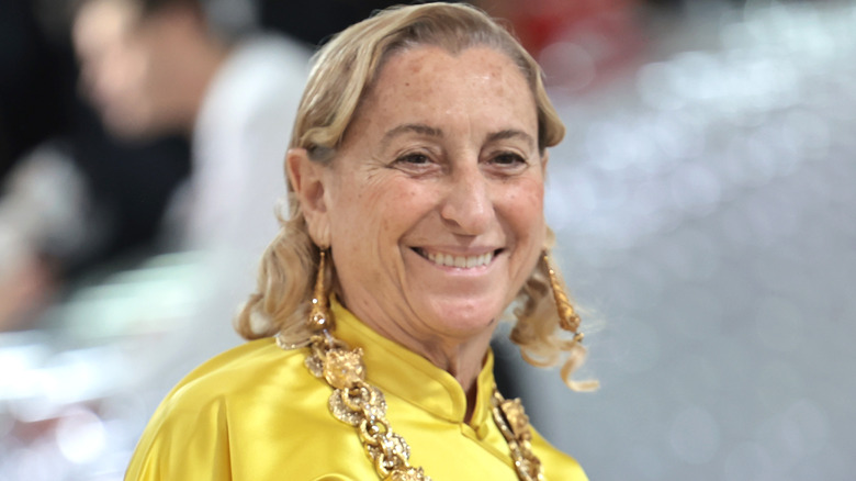 Miuccia Prada smiling in yellow top