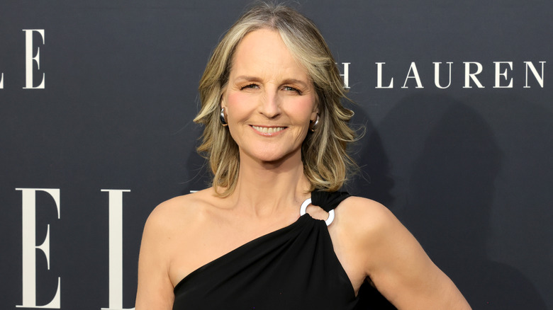 Helen Hunt smiling in a black dress on the red carpet