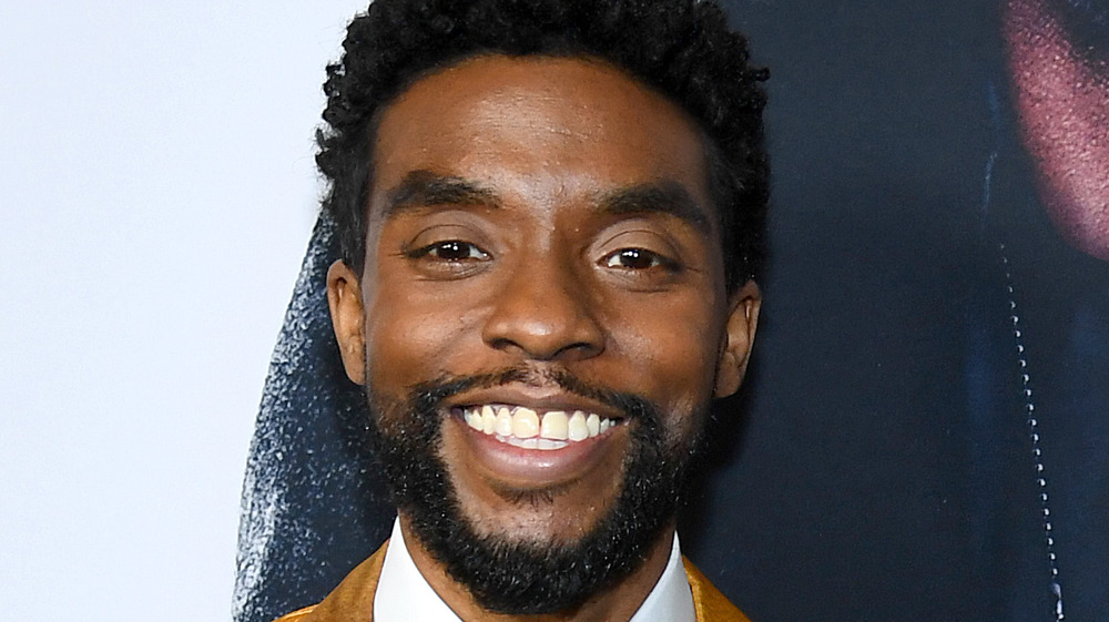 Chadwick Boseman smiling wide for cameras