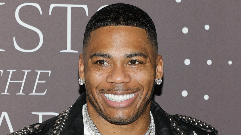Nelly smiling wide with teeth