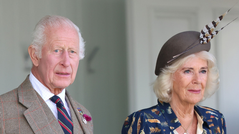 King Charles and Queen Camilla stand side by side in 2024