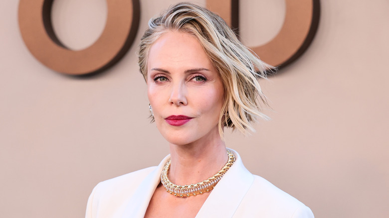 Charlize Theron with side-swept hair at a film premiere.