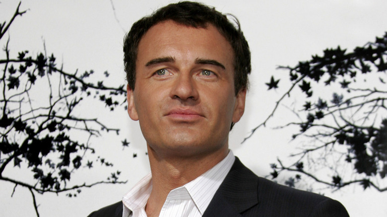Julian McMahon wearing black blazer and white button-down shirt