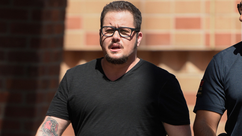 Chaz Bono wearing a black t-shirt and black rimmed glasses