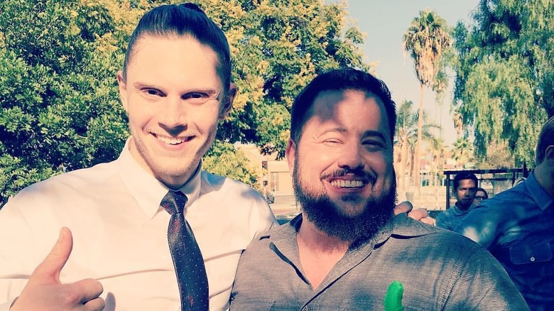 Evan Peters and Chaz Bono in costume on set of "American Horror Story: Cult" with their thumbs up