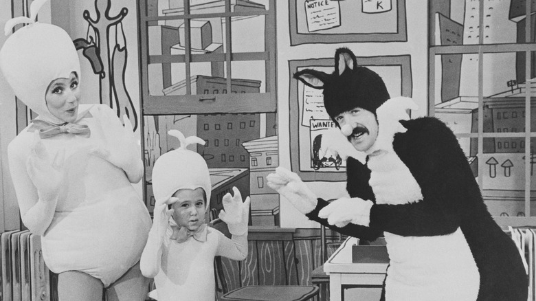 Cher, Chaz Bono, and Sonny Bono dressed in Looney Tunes costumes on set performing