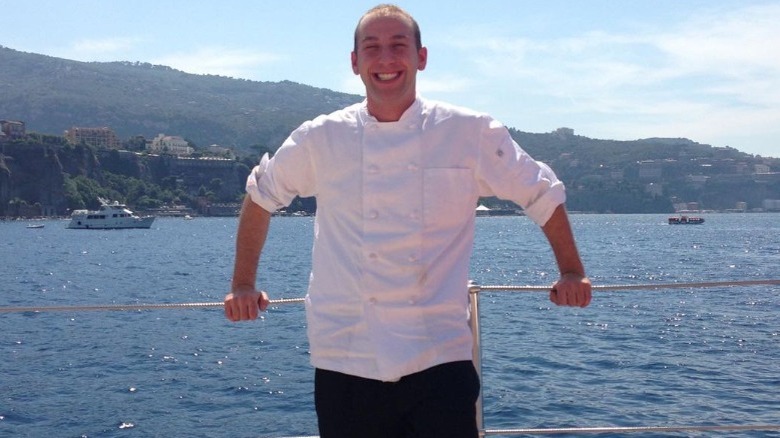 Chef Mathew Shea smiling on a yacht 
