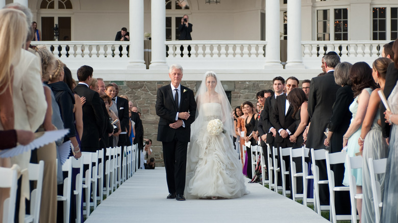 Bill Clinton walks Chelsea Clinton down the aisle at her New York wedding