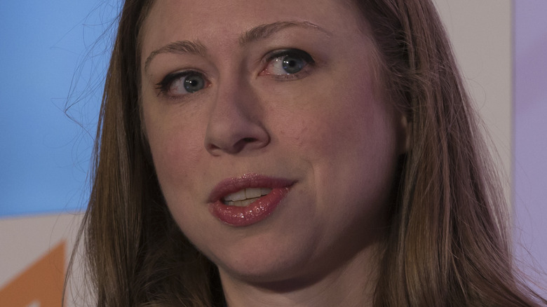 Chelsea Clinton looking left wearing red lipstick