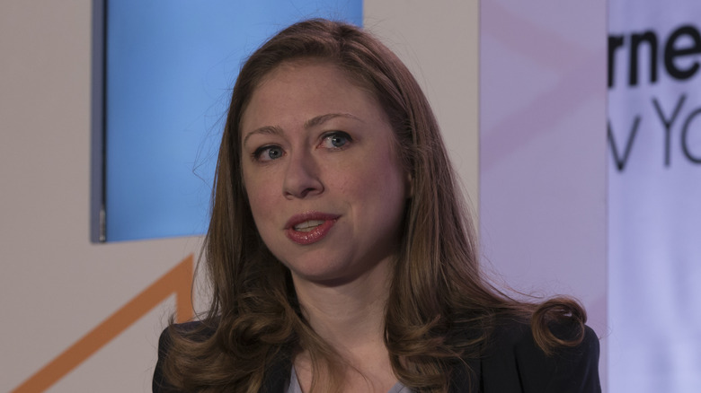 Chelsea Clinton looking left wearing red lipstick