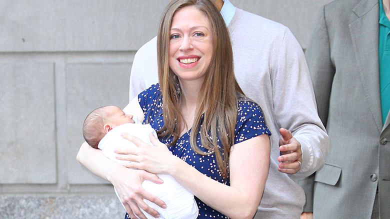 Chelsea Clinton carrying her baby