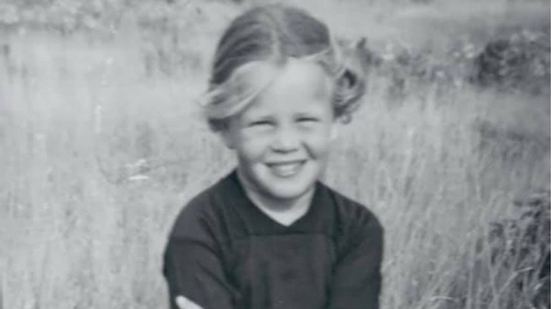 Chelsea Handler posing in a field as a child