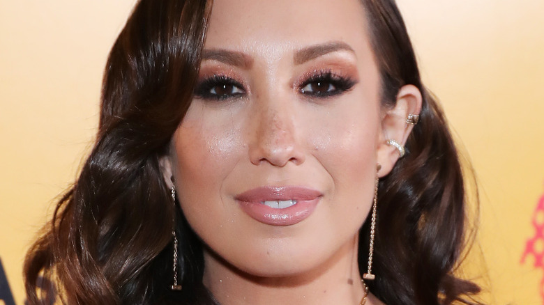 Cheryl Burke smiling at event