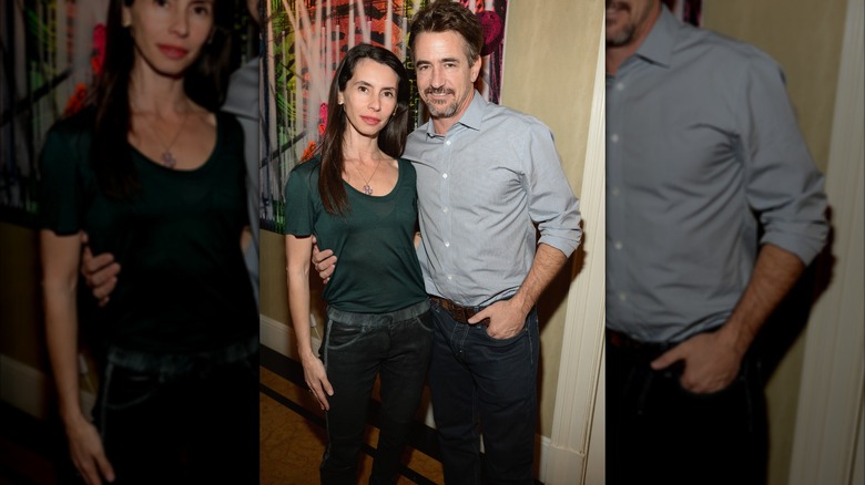 Prima Apollinaare and Dermot Mulroney embracing while posing for photos together in 2015.