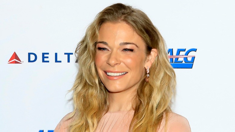 Dressed in a peach number, LeAnn Rimes sports a wide smile