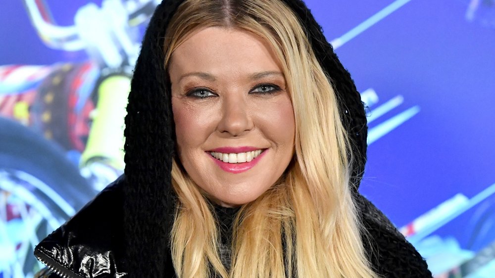 Tara Reid smiling at a red carpet event 