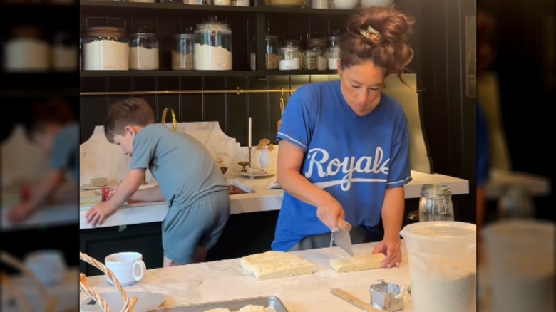 Joanna and Crew Gaines working together in the kitchen.