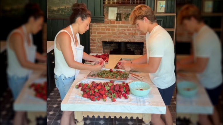 Joanna and Duke Gaines sorting through strawberries.