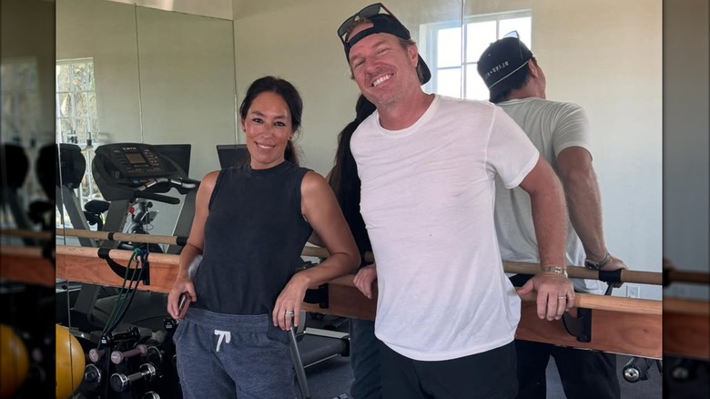 Joanna Gaines and Chip Gaines posing in the gym