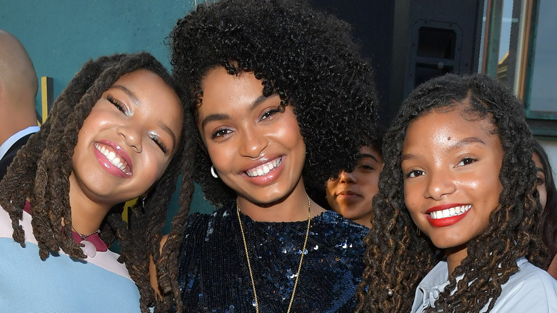 Chloe Bailey, Yara Shahidi, and Halle Bailey posing 