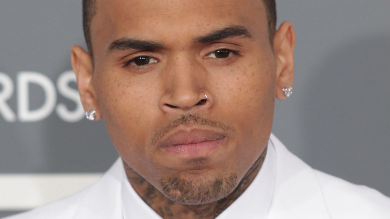 Chris Brown diamond earrings white suit