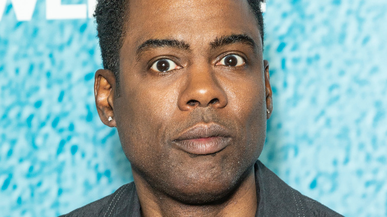 Chris Rock wearing stud earrings