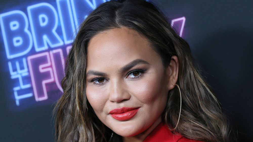 Chrissy Teigen smiling at an event