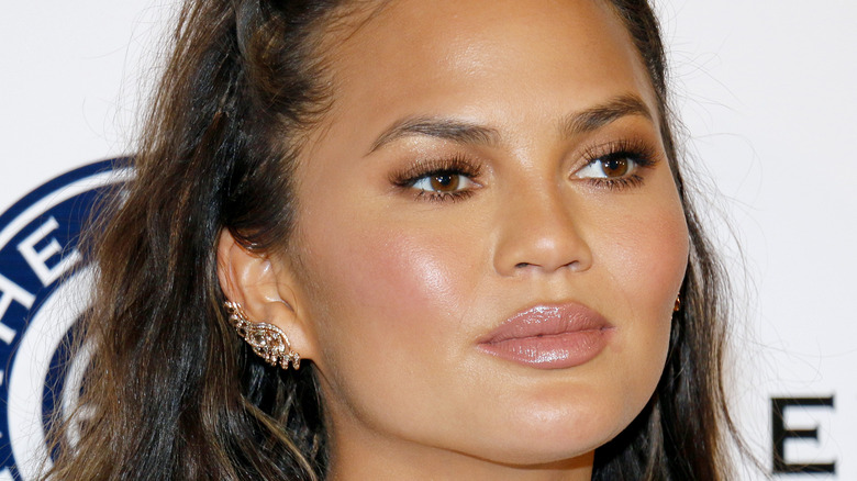 Chrissy Teigen gives a serious look on the red carpet